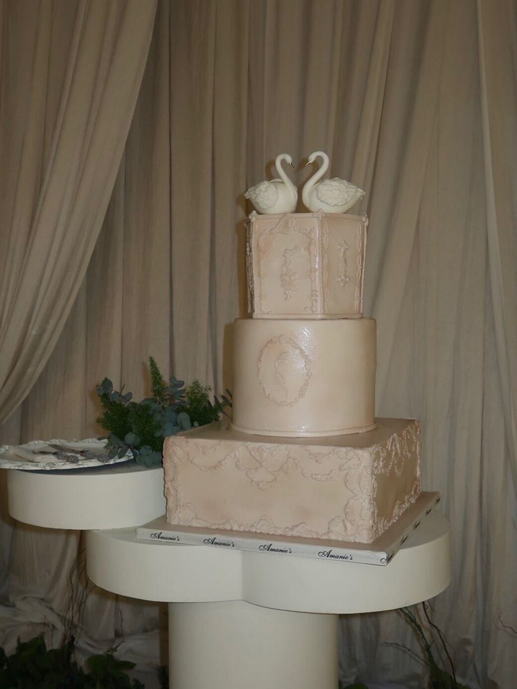 Elegant swan cake featuring a multi-tier custom cake design with white fondant finish, delicate textured detailing.